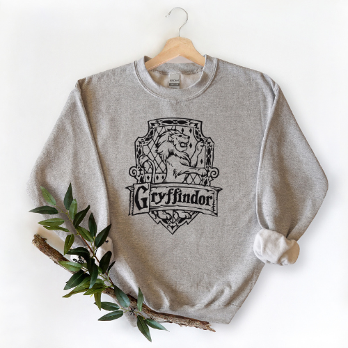 Gray sweatshirt with Gryffindor logo on a hanger against a white background